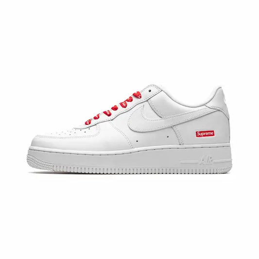 Nike Air Force 1 Supreme White shoe. A white leather shoe with red laces and a red coloured supreme logo